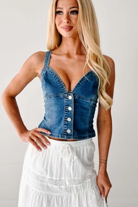 Close-up of blue stretch denim vest with metal buttons and classic topstitching details