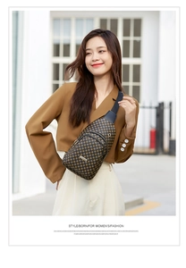 Street style shot of a brown checkerboard pattern crossbody bag worn by a model