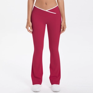 Detail of red crossover high waist flare yoga pants with white contrast piping details