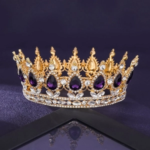 Detail of a luxury gold bridal crown with large purple teardrop rhinestones and gems