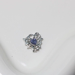 Macro detail of heart purple gemstone pendant with silver spider web and small diamonds