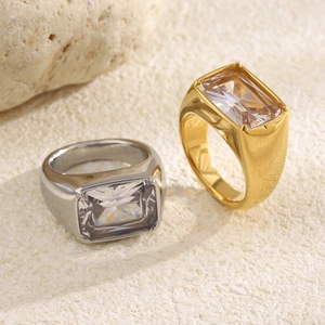 Macro view of gold and silver chunky stainless steel rings with square cubic zirconia