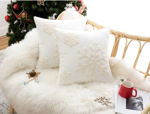 Detailed close-up of white snowflake embroidery on soft Christmas cushion covers