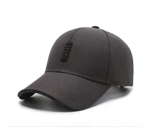 Detailed close-up of dark grey baseball cap with vertical SPORT label and curved brim