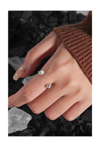 Close-up of irregular pebble-shaped S925 sterling silver ring on hand with aesthetic details