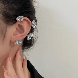 Detail of silver butterfly ear cuff and stud earring with sparkling zircons on model