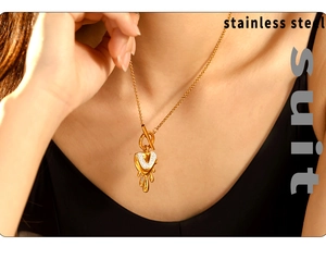 Detail of gold dripping heart pendant with rhinestones on stainless steel OT buckle chain