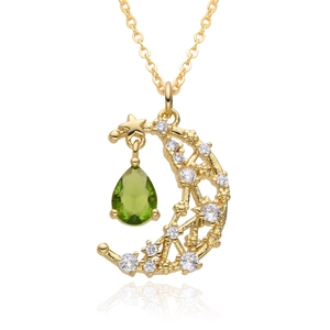 Elegant gold celestial necklace featuring a crescent moon and green pear-shaped gemstone