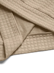 Macro shot of khaki waffle knit fabric texture and high-quality stitching details