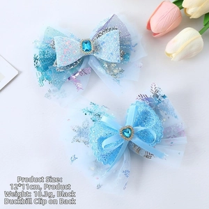 Close-up of blue sequin mesh hair bows with snowflake patterns and crystal heart detail
