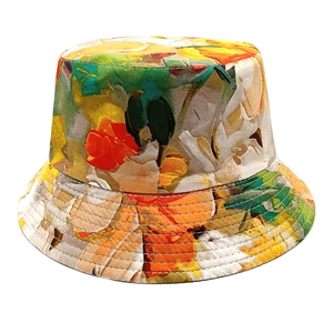 Detailed view of reinforced stitching on colorful floral print canvas bucket hat brim