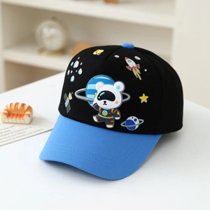 Detailed close-up of cartoon astronaut bear and space rocket patches on kids baseball cap