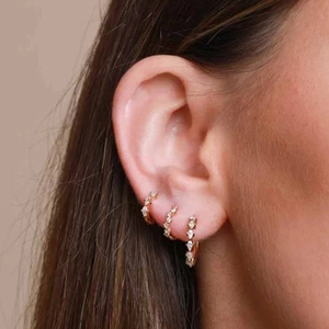 Detail view of gold S925 sterling silver hoop earrings with sparkling micro-pave zircons