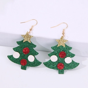 Macro detail of Christmas tree earrings with green glitter finish and gold star top