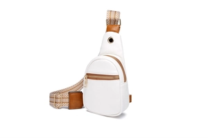 Detailed side view of white leather sling bag with brown strap and gold zipper accents