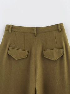 Detail of high-waist olive green trousers featuring belt loops and faux flap pockets
