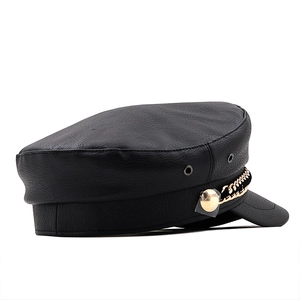 Chic black leather baker boy hat with gold chain accent and polished texture