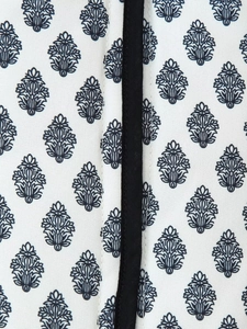 Close-up of premium leaf print cotton fabric with high-density weave and detailed stitching