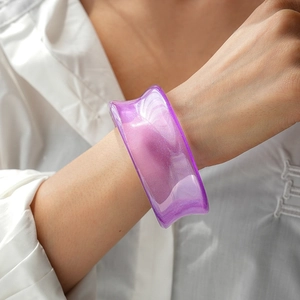 Macro shot of purple translucent resin wide cuff bracelet with fine glitter texture