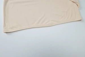 Detailed close-up showing the double-stitched hem and soft textured mesh fabric on a mini dress