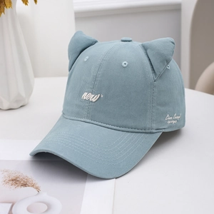 Detailed embroidery of white letters and cat ear design on a light blue baseball cap
