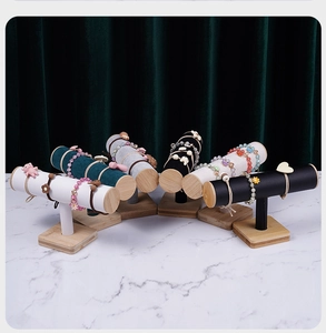 Detailed T-bar jewelry stands with wood bases in velvet and leather finishes