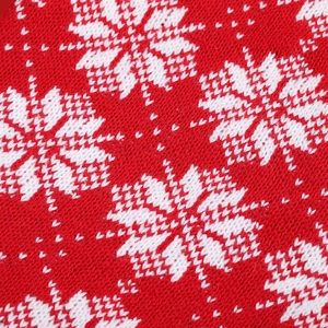 Classic red and white knitted Christmas stocking with intricate snowflake patterns