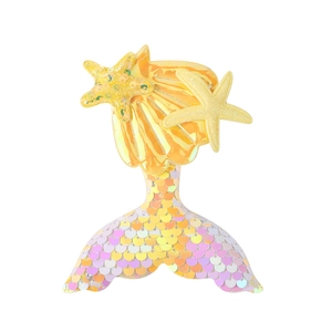 Close-up of mermaid tail hair clip with pink purple sequins and small yellow starfish
