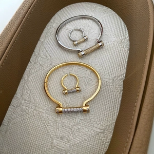 Diamond-encrusted horseshoe D-shape bracelet and ring set in gold and silver plating