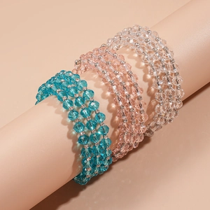 Detailed view of three-layer glass bead bracelets in blue, pink, and clear crystal tones