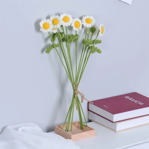 Hand-knitted daisy bouquet made of milk cotton in a wooden base for home decoration
