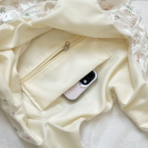 Interior view of silk tote bag showing polyester lining and secure zipper pocket