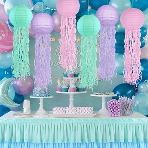 Detail of hanging jellyfish paper lanterns in pastel pink and purple for mermaid parties