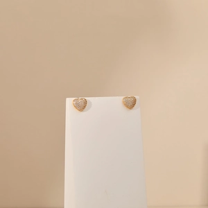 Detailed view of heart-shaped 18K gold earrings with micro-pave white zircon stones