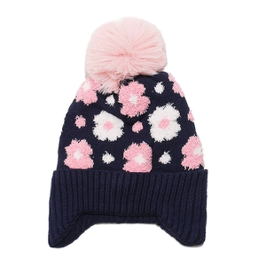 Detail of dark blue knit winter hat for girls with pink floral patterns and a faux fur pompom