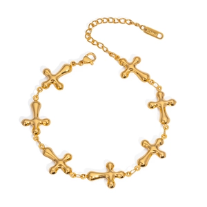 Detailed macro of gold stainless steel link bracelet with multiple cross charms