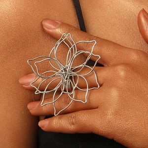 Detailed macro shot of silver hollow-out flower ring with woven metal wire texture
