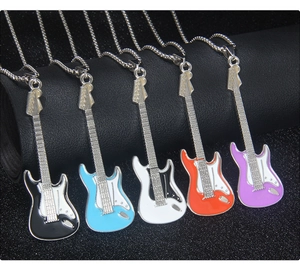 Guitar necklaces in black, blue, white, orange, and purple enamel on a dark background