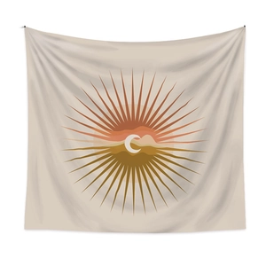 Close-up of boho wall tapestry with sun, moon, and mountain geometric art pattern