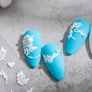 3D embossed floral nail stickers with white flowers and Love text on blue nails