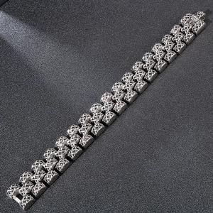 Macro view of men's vintage stainless steel bracelet with triple-row woven texture