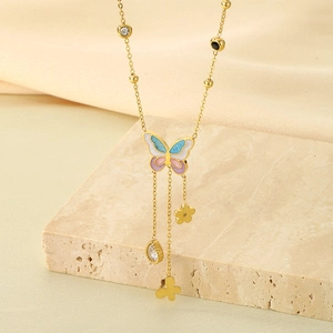 Detail of gold butterfly tassel necklace with blue shell wings and zircon charms