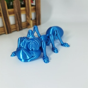 Macro view of blue 3D printed ant model showing detailed layered texture on white background
