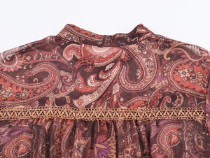 Detail of bohemian paisley chiffon blouse featuring lace splicing and pleated back design