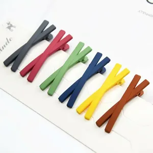Matte candy-colored X-shaped hair clips set in minimalist geometric crossover design