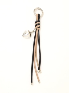 Detail of hand-woven leather keychain with silver heart pendant and stylish fringe