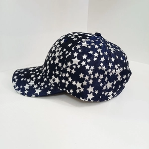 Macro side view of navy blue baseball cap with white star prints and textured fabric details