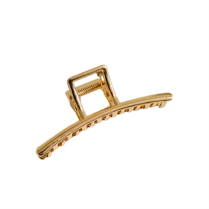 Polished gold square metal hair claw clip with rounded teeth for elegant hairstyling