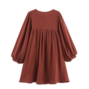 Rust red long-sleeved cotton gauze dress for girls featuring a high waist and pleated skirt