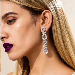 Exaggerated silver number 2026 rhinestone stud earrings shown on model for women